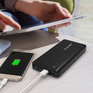portable battery charger charging a phone and laptop