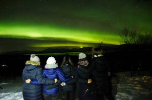 five friends watch the northern lights in january from abisko sweden