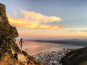a hiker overlooks cape town from table mountain