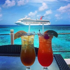the view of a carnival cruiseship with two cocktail glasses