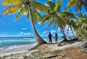 a couple holding hands on a beach at punta cana dominican republic