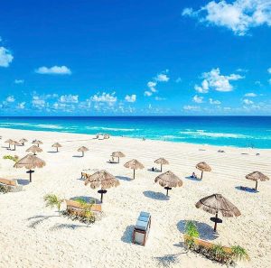 empty beach chairs and umbrellas along the mayan riviera