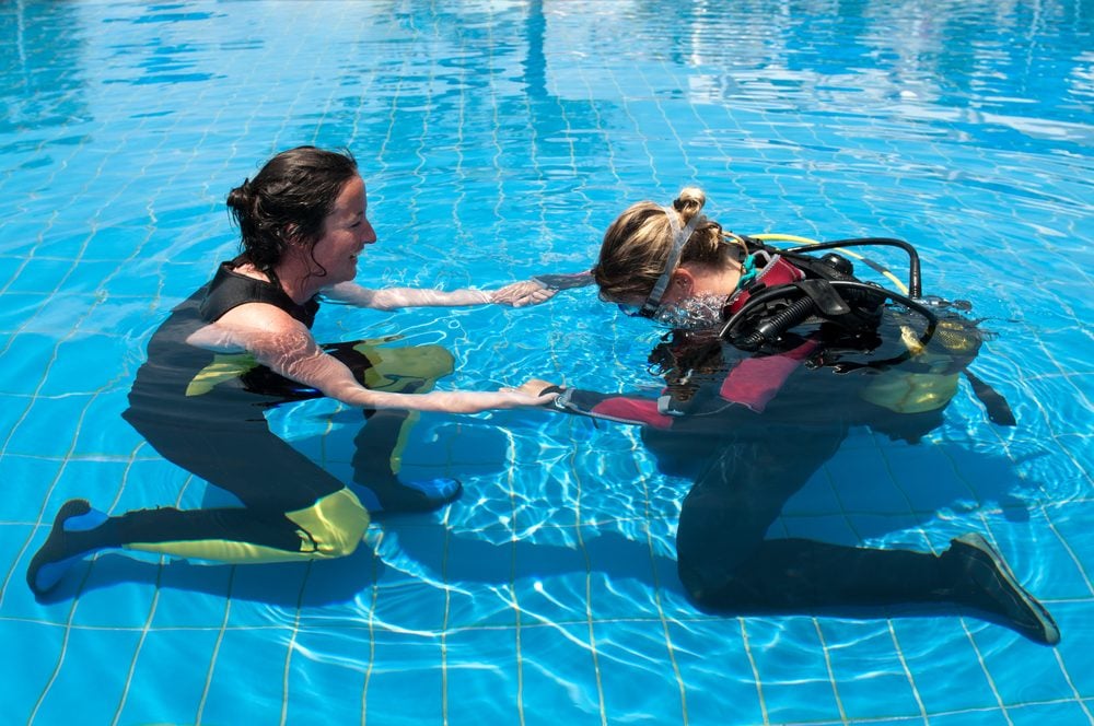 Learning to scuba dive in pool