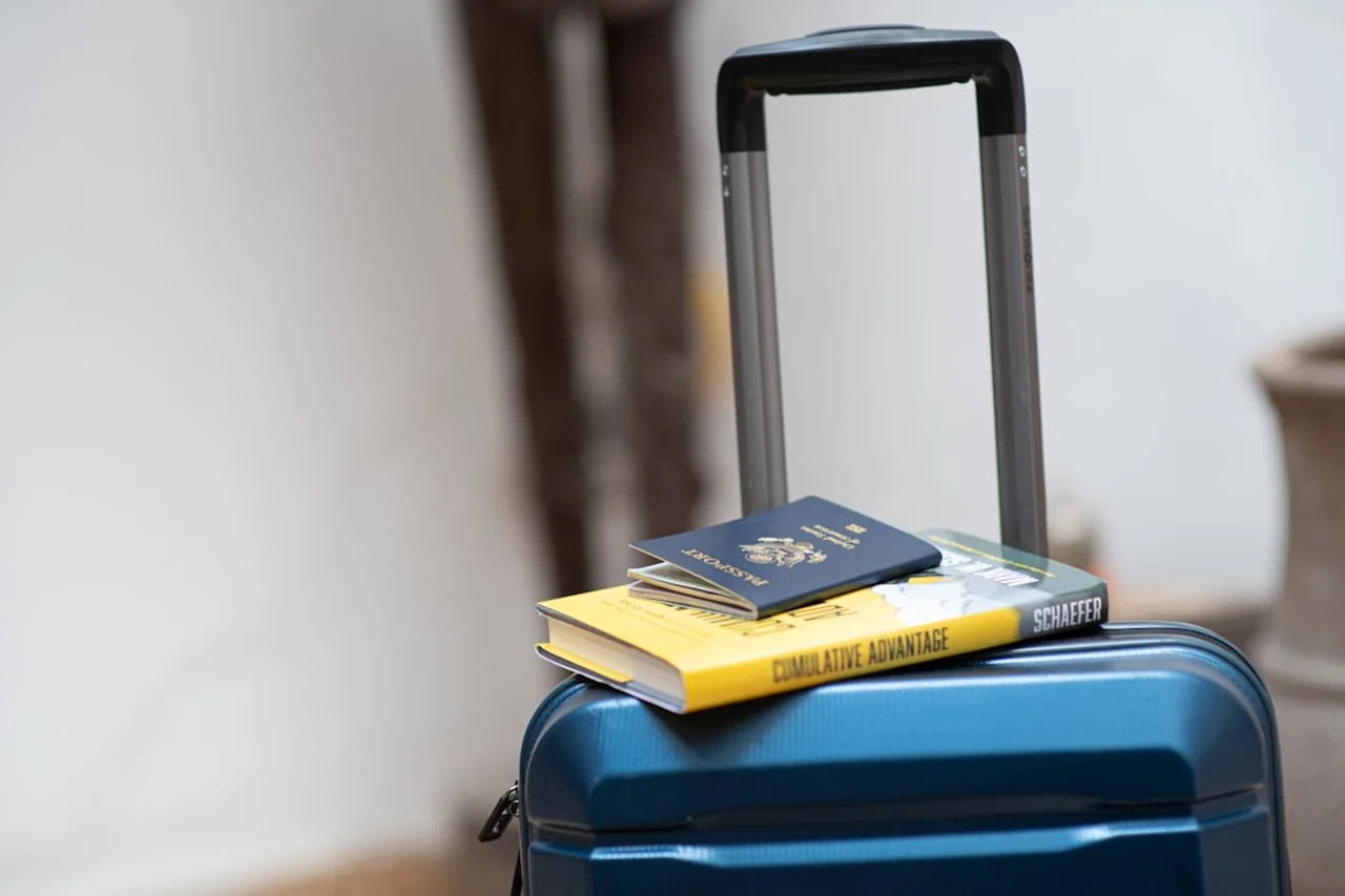Passenger placing carry-on bag in overhead bin on Air France flight
