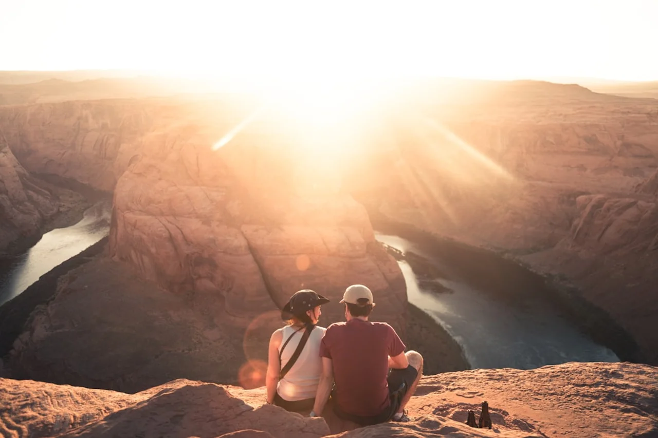 Two travelers taking in scenic views from a lookout on an affordable vacation booked with eDreams Prime.